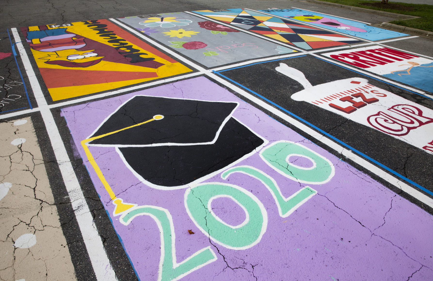 Students painting their parking spaces
